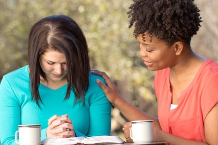 women praying together